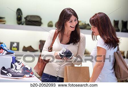 Women sisters 35 and 40 years shopping at a shoe store. Donostia. San Sebastian. Gipuzkoa. Basque Country- Spain. View Large Photo Image Stock Image - Women sisters 35 and 40 years shopping at a shoe store. Donostia. San Sebastian. Gipuzkoa. Basque Country- Spain.. Fotosearch
