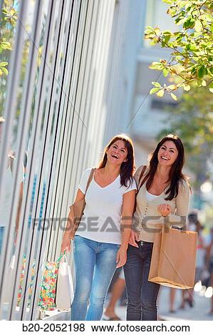 Women sisters 35 and 40 years shopping on the street. Donostia. San Sebastian. Gipuzkoa. Basque Country- Spain. View Large Photo Image Stock Photo - Women sisters 35 and 40 years shopping on the street. Donostia. San Sebastian. Gipuzkoa. Basque Country- Spain.. Fotosearch