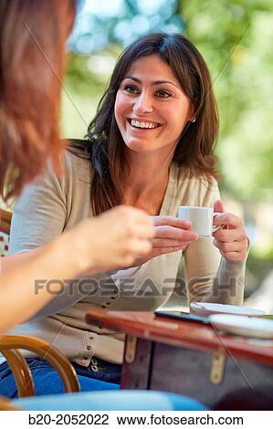 Stock Image - Women sisters 35 and 40 years taking coffee on a terrace. Donostia. San Sebastian. Gipuzkoa. Basque Country- Spain.. Fotosearch