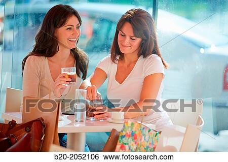 Women sisters 35 and 40 years taking coffee on a terrace. Donostia. San Sebastian. Gipuzkoa. Basque Country- Spain. View Large Photo Image Stock Photograph - Women sisters 35 and 40 years taking coffee on a terrace. Donostia. San Sebastian. Gipuzkoa. Basque Country- Spain.. Fotosearch