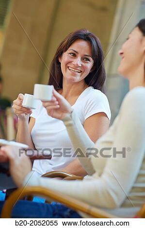 Women sisters 35 and 40 years taking coffee on a terrace. Donostia. San Sebastian. Gipuzkoa. Basque Country- Spain. View Large Photo Image Stock Photography - Women sisters 35 and 40 years taking coffee on a terrace. Donostia. San Sebastian. Gipuzkoa. Basque Country- Spain.. Fotosearch