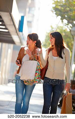 Women sisters 35 and 40 years with a drink. Shopping on the street. Donostia. San Sebastian. Gipuzkoa. Basque Country. Spain. View Large Photo Image Stock Photo - Women sisters 35 and 40 years with a drink. Shopping on the street. Donostia. San Sebastian. Gipuzkoa. Basque Country. Spain.. Fotosearch