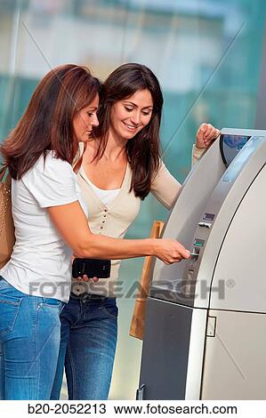 Women sisters 35 and 40 years with credit card at ATM. Shopping on the street. Donostia. San Sebastian. Gipuzkoa. Basque Country- Spain. View Large Photo Image Stock Image - Women sisters 35 and 40 years with credit card at ATM. Shopping on the street. Donostia. San Sebastian. Gipuzkoa. Basque Country- Spain.. Fotosearch