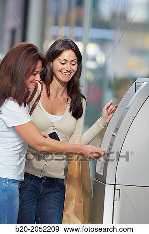 Women sisters 35 and 40 years with credit card at ATM. Shopping on the street. Donostia. San Sebastian. Gipuzkoa. Basque Country- Spain. View Large Photo Image Stock Photo - Women sisters 35 and 40 years with credit card at ATM. Shopping on the street. Donostia. San Sebastian. Gipuzkoa. Basque Country- Spain.. Fotosearch