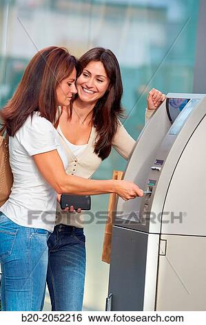 Women sisters 35 and 40 years with credit card at ATM. Shopping on the street. Donostia. San Sebastian. Gipuzkoa. Basque Country- Spain. View Large Photo Image Stock Photograph - Women sisters 35 and 40 years with credit card at ATM. Shopping on the street. Donostia. San Sebastian. Gipuzkoa. Basque Country- Spain.. Fotosearch