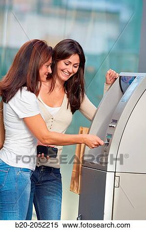 Women sisters 35 and 40 years with credit card at ATM. Shopping on the street. Donostia. San Sebastian. Gipuzkoa. Basque Country- Spain. View Large Photo Image Stock Photography - Women sisters 35 and 40 years with credit card at ATM. Shopping on the street. Donostia. San Sebastian. Gipuzkoa. Basque Country- Spain.. Fotosearch