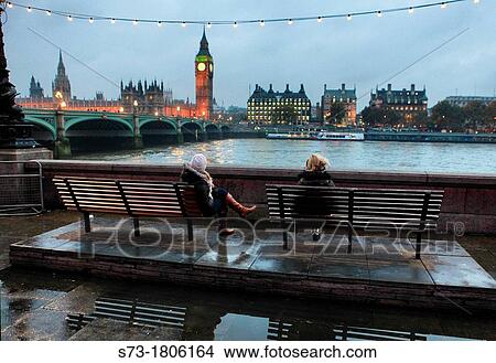 Women sitting and view of the Houses of Parliament, Westminster Bridge and The River Thames, London, England View Large Photo Image Picture - Women sitting and view of the Houses of Parliament, Westminster Bridge and The River Thames, London, England. Fotosearch