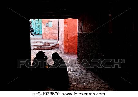 Women sitting under a passage in Marrakech medina, Morocco. View Large Photo Image Stock Image - Women sitting under a passage in Marrakech medina, Morocco.. Fotosearch