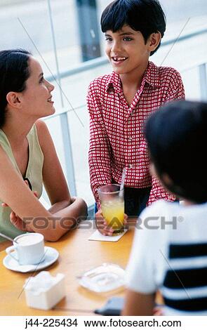 Picture - Women with boy in caf?. Fotosearch