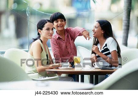 Stock Image - Women with boy in outdoor caf?. Isla de Margarita, Nueva Esparta, Venezuela. Fotosearch