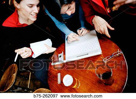 Women with laptop having a drink in a pub. London. England View Large Photo Image Stock Photo - Women with laptop having a drink in a pub. London. England. Fotosearch