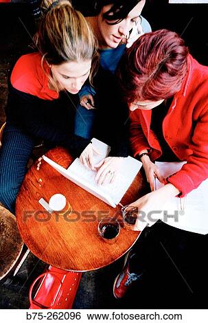Women with laptop having a drink in a pub. London. England View Large Photo Image Stock Photograph - Women with laptop having a drink in a pub. London. England. Fotosearch