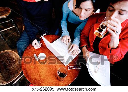 Women with laptop having a drink in a pub. London. England View Large Photo Image Stock Photography - Women with laptop having a drink in a pub. London. England. Fotosearch