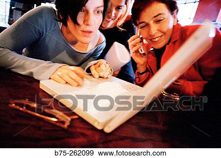 Stock Photo - Women with laptop in a pub. London. England. Fotosearch