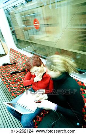 Women with laptop in the tube View Large Photo Image Picture - Women with laptop in the tube. Fotosearch