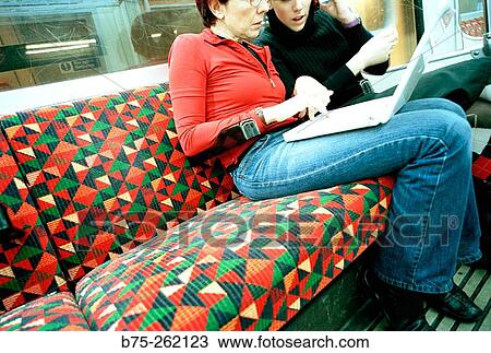 Women with laptop in the tube View Large Photo Image Stock Image - Women with laptop in the tube. Fotosearch