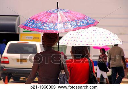 Women with parasol at Maun, Botswana View Large Photo Image Stock Image - Women with parasol at Maun, Botswana. Fotosearch