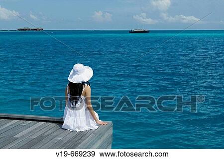 Womon Sitting on Ocean, Maldives View Large Photo Image Stock Photo - Womon Sitting on Ocean, Maldives. Fotosearch