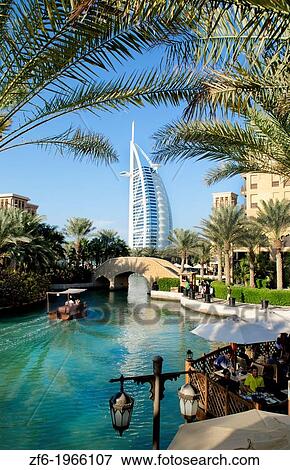 Wonderful 7 star Burj Al Arab hotel from the shopping mall at Madinat Jumeirah with boat and restaurants with palms in Dubai UAE inn thriving United Arab Emirates. View Large Photo Image Stock Photo - Wonderful 7 star Burj Al Arab hotel from the shopping mall at Madinat Jumeirah with boat and restaurants with palms in Dubai UAE inn thriving United Arab Emirates.. Fotosearch