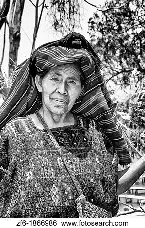 Wonderful colorful portrait of older local woman in colorful dress in Panajachel on remote Lake Atitlan in Guatemala View Large Photo Image Stock Photograph - Wonderful colorful portrait of older local woman in colorful dress in Panajachel on remote Lake Atitlan in Guatemala. Fotosearch