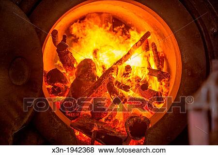 Wood burning in a stove for canola oil (rapeseed) production at Molinera Gorbea, a grain processor involved in the manufacture of fish food in Temuco, Chile. View Large Photo Image Stock Photo - Wood burning in a stove for canola oil (rapeseed) production at Molinera Gorbea, a grain processor involved in the manufacture of fish food in Temuco, Chile.. Fotosearch