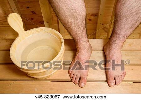 Wooden bucket and legs of a man sitting in sauna View Large Photo Image Stock Photo - Wooden bucket and legs of a man sitting in sauna. Fotosearch
