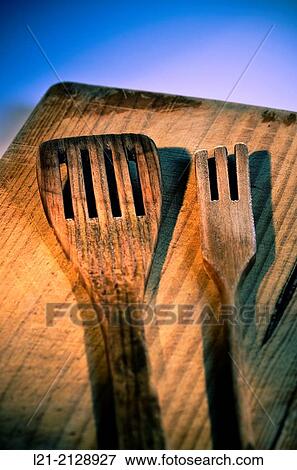 Stock Photo - Wooden spatula and fork on a wooden surface.. Fotosearch