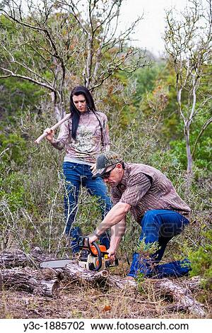 Woodworkers sawing branch of fallen oak tree, male, 40 years, Caucasian, female, 18 years, Caucasian, chainsaw, ax, Texas, USA View Large Photo Image Stock Image - Woodworkers sawing branch of fallen oak tree, male, 40 years, Caucasian, female, 18 years, Caucasian, chainsaw, ax, Texas, USA. Fotosearch