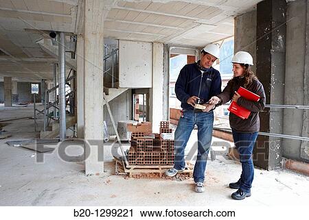 Worker and technician, new homes under construction, construction site View Large Photo Image Stock Image - Worker and technician, new homes under construction, construction site. Fotosearch