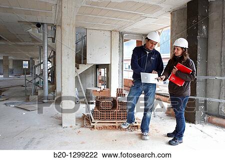 Worker and technician, new homes under construction, construction site View Large Photo Image Stock Image - Worker and technician, new homes under construction, construction site. Fotosearch