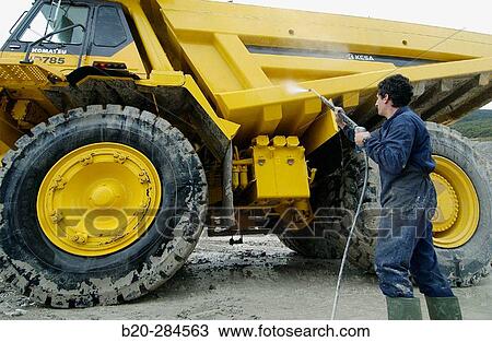 Worker cleaning dumper-truck to carry marl from quarry to cement plant View Large Photo Image Stock Image - Worker cleaning dumper-truck to carry marl from quarry to cement plant. Fotosearch