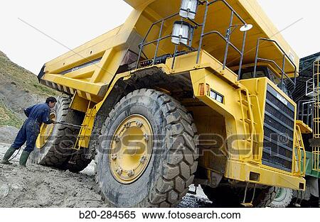 Worker cleaning dumper-truck to carry marl from quarry to cement plant View Large Photo Image Stock Photography - Worker cleaning dumper-truck to carry marl from quarry to cement plant. Fotosearch