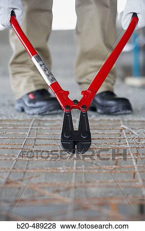 Worker cutting wire in plank mould with pliers. Housing construction, apartments. San Sebastian, Gipuzkoa, Euskadi. Spain. View Large Photo Image Stock Photo - Worker cutting wire in plank mould with pliers. Housing construction, apartments. San Sebastian, Gipuzkoa, Euskadi. Spain.. Fotosearch