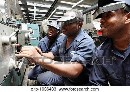 Worker explains lathe to colleagues View Large Photo Image Stock Image - Worker explains lathe to colleagues. Fotosearch
