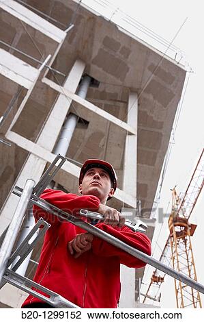 Worker holding adjustable spanner in a construction site View Large Photo Image Stock Image - Worker holding adjustable spanner in a construction site. Fotosearch