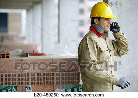 Stock Image - Worker. Housing construction, apartments. San Sebastian, Gipuzkoa, Euskadi. Spain.. Fotosearch