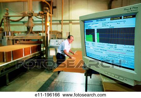 Stock Photograph - Worker measuring material. Fotosearch