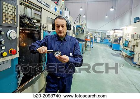 Worker measuring with caliper. Area automated CNC lathes. Machined Indecober. Machining of precision parts in series. Automotive industry. Berriz. Bizkaia. Basque Country. Spain. View Large Photo Image Stock Image - Worker measuring with caliper. Area automated CNC lathes. Machined Indecober. Machining of precision parts in series. Automotive industry. Berriz. Bizkaia. Basque Country. Spain.. Fotosearch