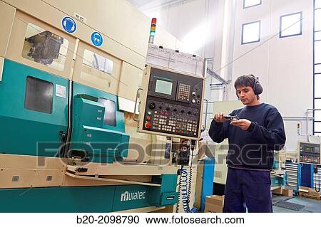Worker measuring with caliper. Area automated CNC lathes. Machined Indecober. Machining of precision parts in series. Automotive industry. Berriz. Bizkaia. Basque Country. Spain. View Large Photo Image Stock Image - Worker measuring with caliper. Area automated CNC lathes. Machined Indecober. Machining of precision parts in series. Automotive industry. Berriz. Bizkaia. Basque Country. Spain.. Fotosearch