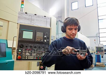 Worker measuring with caliper. Area automated CNC lathes. Machined Indecober. Machining of precision parts in series. Automotive industry. Berriz. Bizkaia. Basque Country. Spain. View Large Photo Image Stock Image - Worker measuring with caliper. Area automated CNC lathes. Machined Indecober. Machining of precision parts in series. Automotive industry. Berriz. Bizkaia. Basque Country. Spain.. Fotosearch