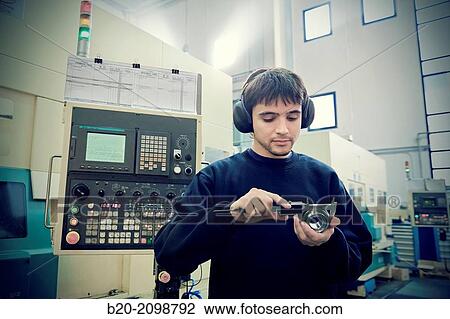 Worker measuring with caliper. Area automated CNC lathes. Machined Indecober. Machining of precision parts in series. Automotive industry. Berriz. Bizkaia. Basque Country. Spain. View Large Photo Image Stock Image - Worker measuring with caliper. Area automated CNC lathes. Machined Indecober. Machining of precision parts in series. Automotive industry. Berriz. Bizkaia. Basque Country. Spain.. Fotosearch