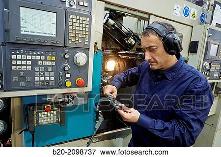 Worker measuring with caliper. Area automated CNC lathes. Machined Indecober. Machining of precision parts in series. Automotive industry. Berriz. Bizkaia. Basque Country. Spain. View Large Photo Image Stock Photo - Worker measuring with caliper. Area automated CNC lathes. Machined Indecober. Machining of precision parts in series. Automotive industry. Berriz. Bizkaia. Basque Country. Spain.. Fotosearch