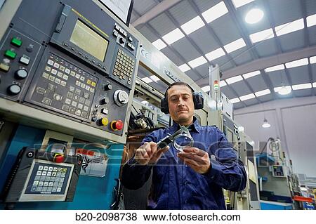 Worker measuring with caliper. Area automated CNC lathes. Machined Indecober. Machining of precision parts in series. Automotive industry. Berriz. Bizkaia. Basque Country. Spain. View Large Photo Image Stock Photo - Worker measuring with caliper. Area automated CNC lathes. Machined Indecober. Machining of precision parts in series. Automotive industry. Berriz. Bizkaia. Basque Country. Spain.. Fotosearch