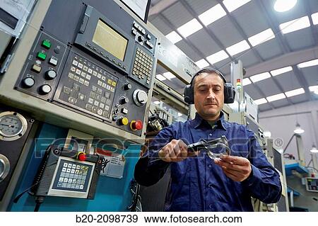 Worker measuring with caliper. Area automated CNC lathes. Machined Indecober. Machining of precision parts in series. Automotive industry. Berriz. Bizkaia. Basque Country. Spain. View Large Photo Image Stock Photo - Worker measuring with caliper. Area automated CNC lathes. Machined Indecober. Machining of precision parts in series. Automotive industry. Berriz. Bizkaia. Basque Country. Spain.. Fotosearch