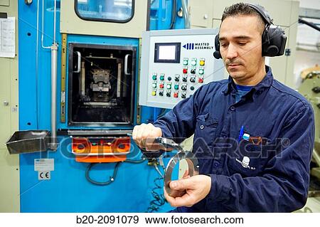 Worker measuring with caliper. Locking nut. Transfer machining. Machined Indecober. Machining of precision parts in series. Automotive industry. Berriz. Bizkaia. Basque Country. Spain. View Large Photo Image Stock Photo - Worker measuring with caliper. Locking nut. Transfer machining. Machined Indecober. Machining of precision parts in series. Automotive industry. Berriz. Bizkaia. Basque Country. Spain.. Fotosearch