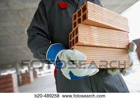 Worker picking bricks. Housing construction, apartments. San Sebastian, Gipuzkoa, Euskadi. Spain. View Large Photo Image Stock Photo - Worker picking bricks. Housing construction, apartments. San Sebastian, Gipuzkoa, Euskadi. Spain.. Fotosearch