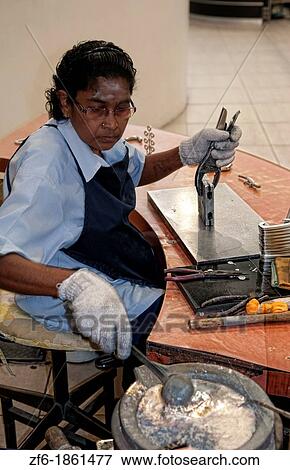 Worker pouring hot fluid in molds in Pewter Factory called Royal Selangor in Kuala Lumpur Malaysia Asia View Large Photo Image Stock Photo - Worker pouring hot fluid in molds in Pewter Factory called Royal Selangor in Kuala Lumpur Malaysia Asia. Fotosearch