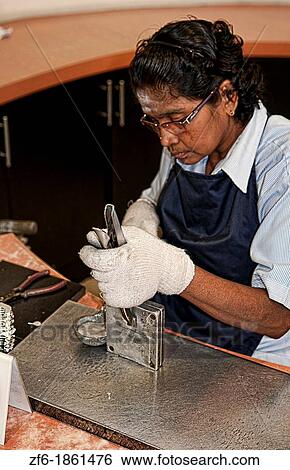Worker pouring hot fluid in molds in Pewter Factory called Royal Selangor in Kuala Lumpur Malaysia Asia View Large Photo Image Stock Photograph - Worker pouring hot fluid in molds in Pewter Factory called Royal Selangor in Kuala Lumpur Malaysia Asia. Fotosearch