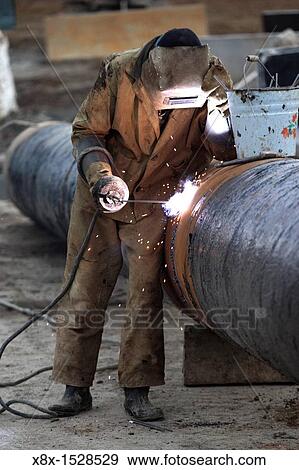 Worker soldering a tube View Large Photo Image Stock Photo - Worker soldering a tube. Fotosearch