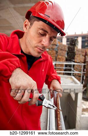 Worker using pliers in construction site, preparing concrete rods View Large Photo Image Stock Image - Worker using pliers in construction site, preparing concrete rods. Fotosearch